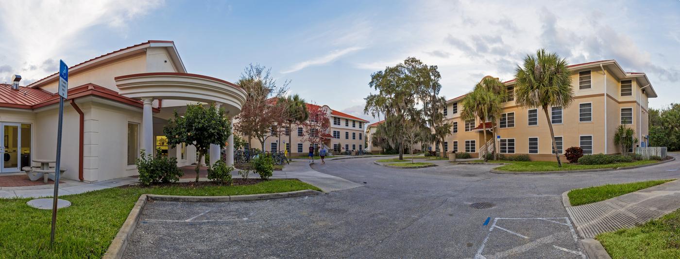 A panoramic view of columbia village showing a group of large stucco apartment buildings